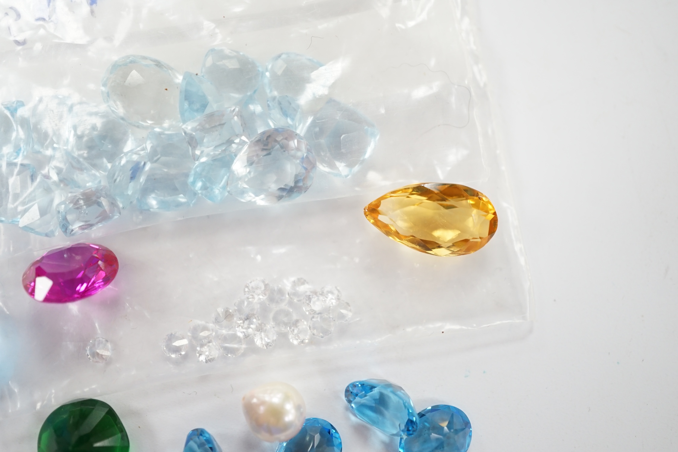 A small quantity of unmounted cut gemstones including diamonds and aquamarine. Fair condition.